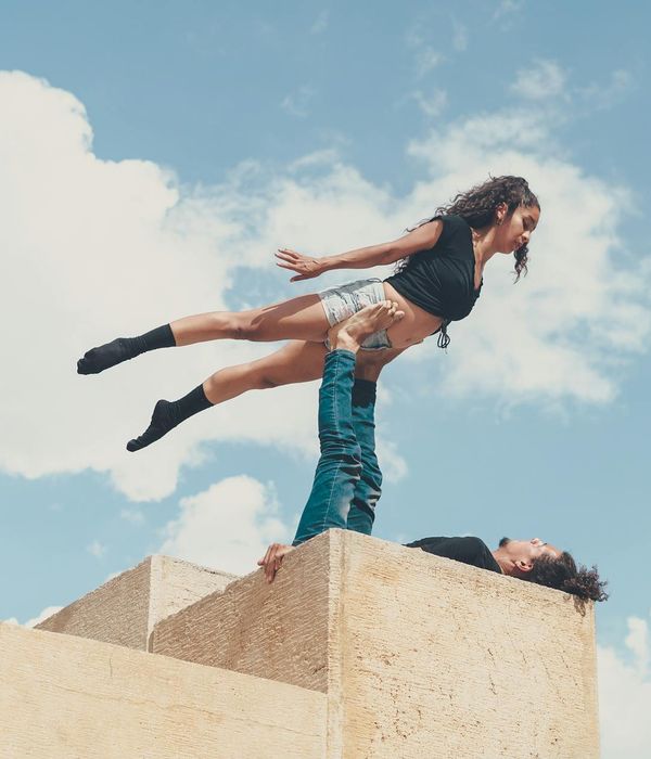 Fit man performing a controlled strength exercise in a minimalist setting.